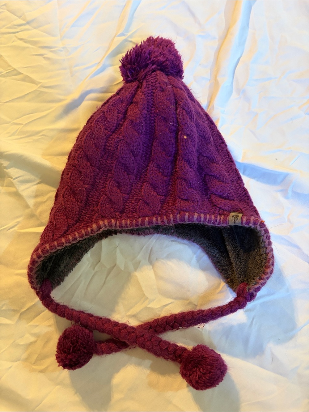 The North Face Kids Cable-Knit Pom Earflap Hat in Purple